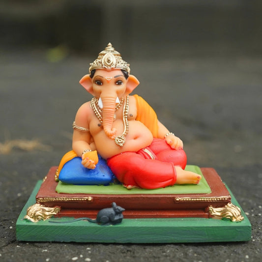 Ganpati Bappa seated on a traditional pat, 4 inch Ganesh idol