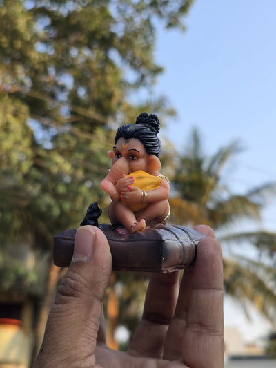Handcrafted Ushi Bal Ganesh murti holding a modak, 4.5 inch Ganpati idol